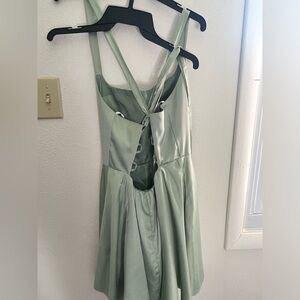 This is a mint green dress worn for homecoming. It’s silky cross tie back.